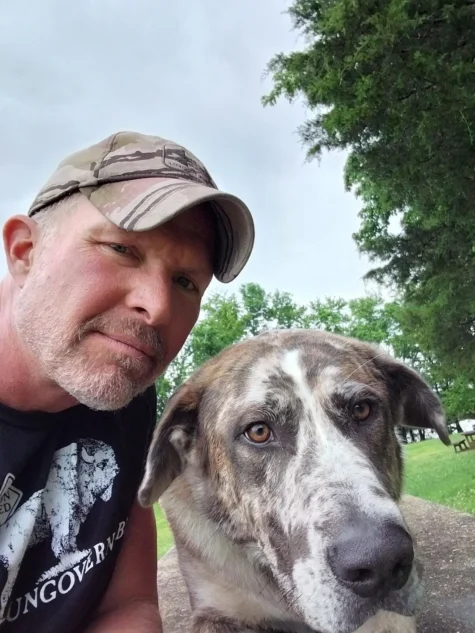 Dog trainer Chris with a Belgian Malinois on his shoulders