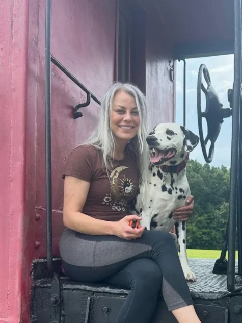 Dog trainer Heather sitting with a Dalmatian